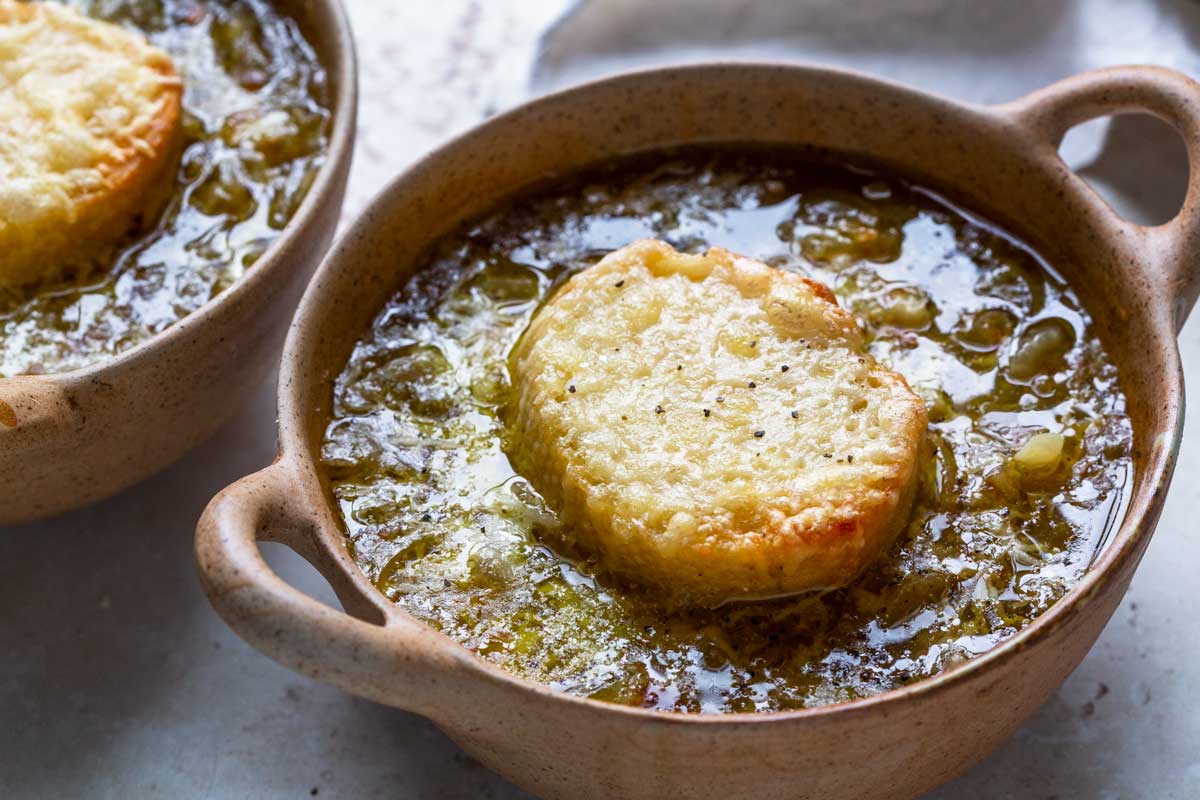 Crocks of french onion soup topped with cheesy toast. 