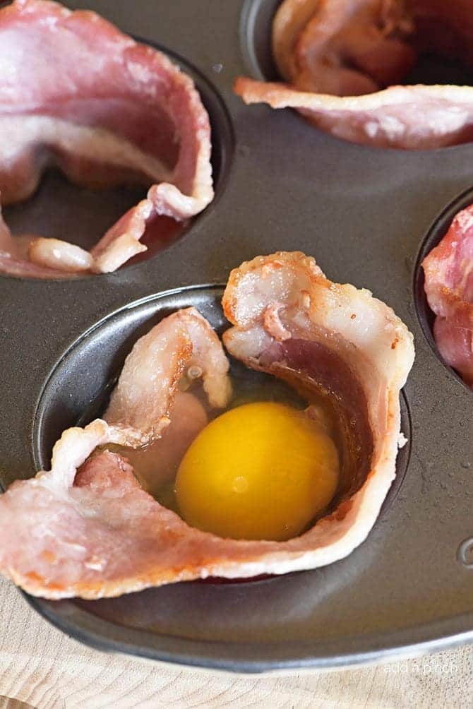 Bacon Egg Cups Recipe - Bacon Egg Cups make a delicious recipe perfect for serving for breakfast, brunch or snack! Great to make for a crowd or to make ahead and reheat for busy mornings! // addapinch.com