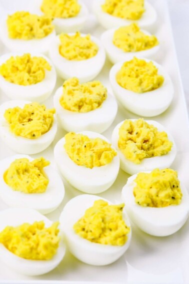 Deviled eggs make the perfect appetizer or side dish for family meals, parties, holidays, potlucks, picnics and more. This simple and classic deviled eggs recipe is a family favorite! // addapinch.com