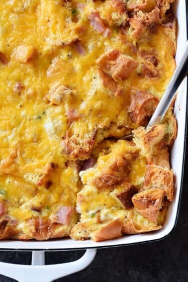 Ham and Cheese Croissant Casserole Recipe - An easy and delicious breakfast casserole that everyone loves! Made of ham, two cheeses, and buttery croissants and baked to perfection! // addapinch.com