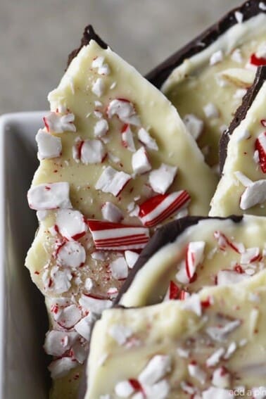 Homemade Peppermint Bark Recipe - Peppermint Bark makes a favorite holiday treat! This homemade peppermint bark recipe is made with layers of peppermint filled milk chocolate and white chocolate and then topped with peppermint candy. // addapinch.com