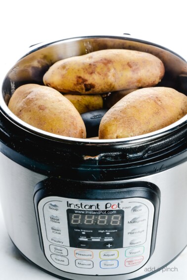 Instant Pot "Baked" Potatoes make a quick and easy way to prepare baked potatoes! Ready in less than 30 minutes! // addapinch.com
