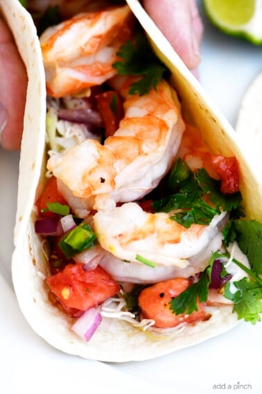 Shrimp Tacos Recipe - These quick and easy shrimp tacos are always a favorite. Made with delicious, tender grilled shrimp, pico de gallo in a soft taco. // addapinch.com