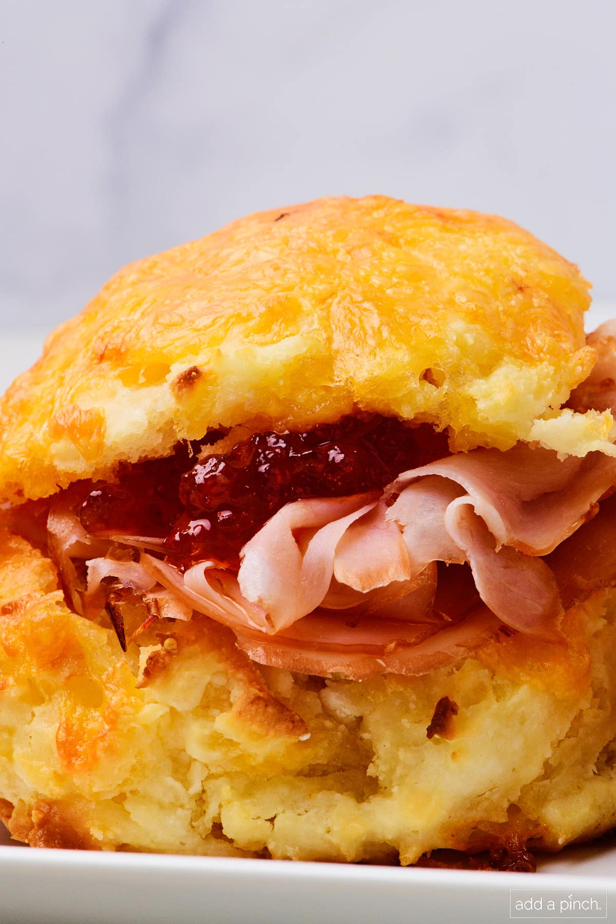 Photo of southern ham biscuit on a white platter.